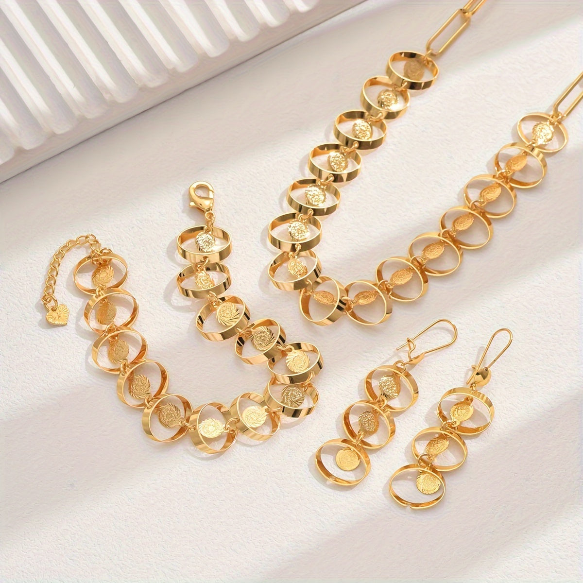 Set of four exquisite and elegant vintage-inspired women's jewelry pieces in 18K gold plating, perfect for a fashionable banquet. Includes a necklace, earrings, bracelet, and ornament.