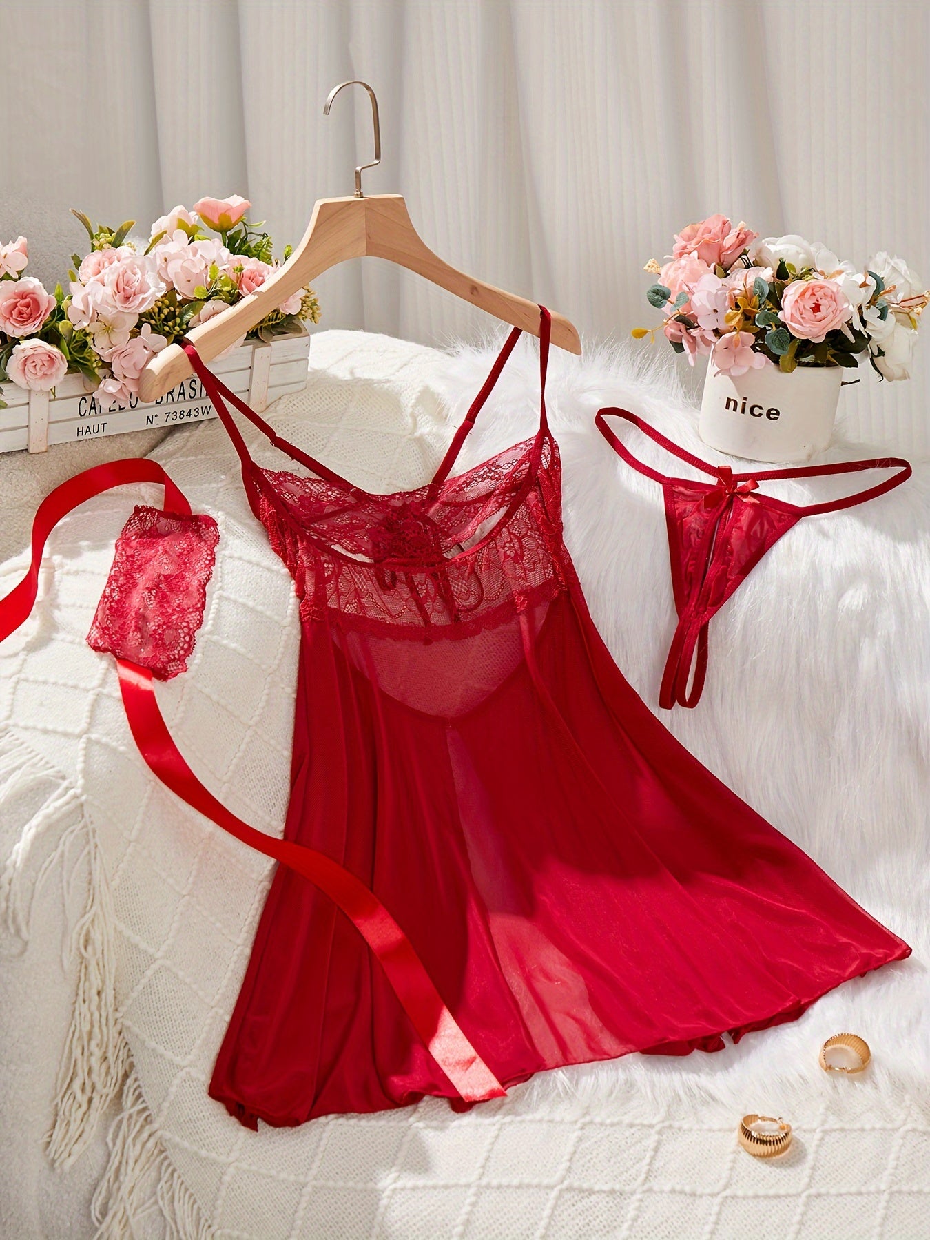 Red lingerie set featuring babydoll dress, G-string panty, eye mask, lace detail, satin ribbon accents - perfect for seductive boudoir attire.