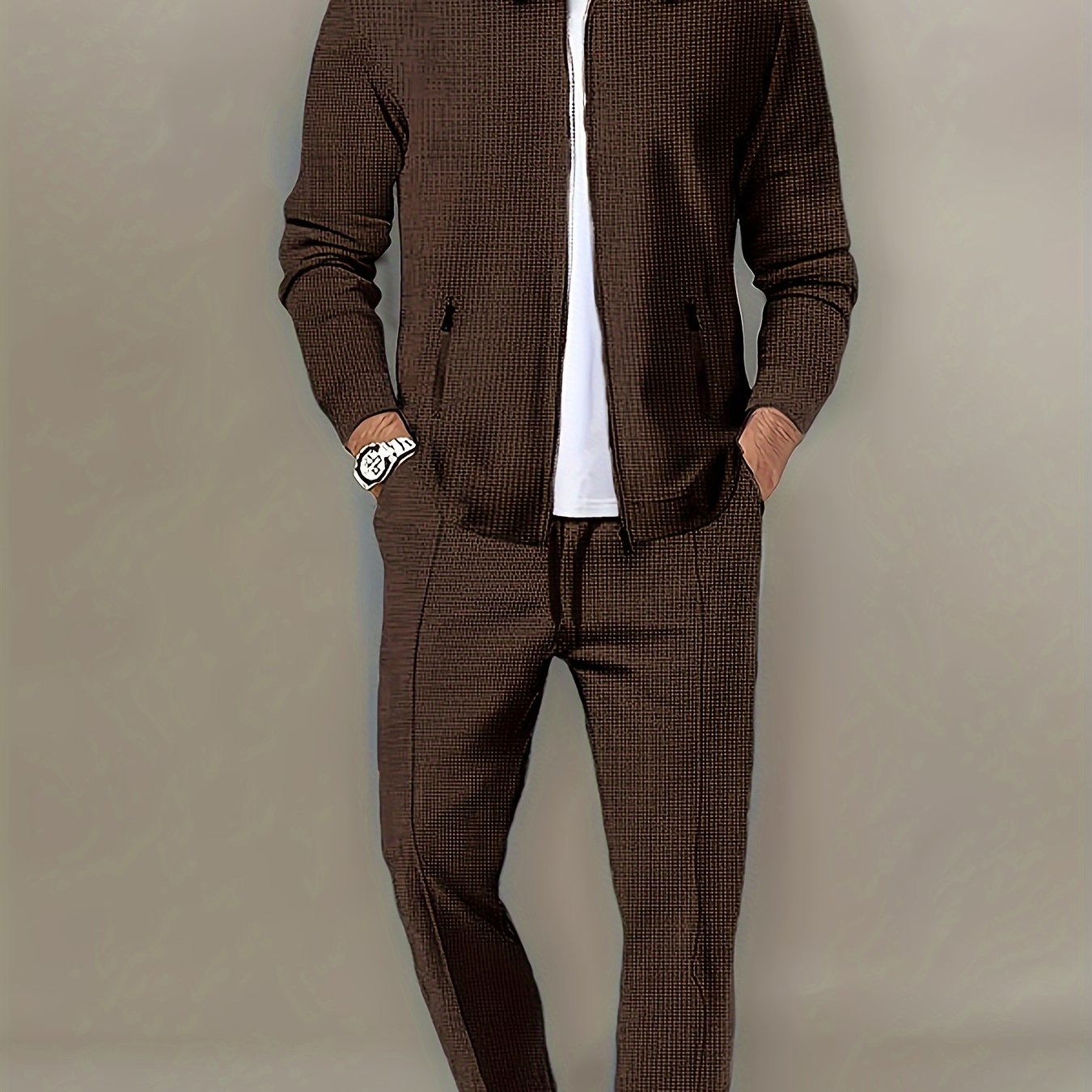 Polyester sports suit with waffle texture, casual lapel jacket and long pants set with zipper detail, solid color loose knit fabric, long sleeves, full polyester composition.