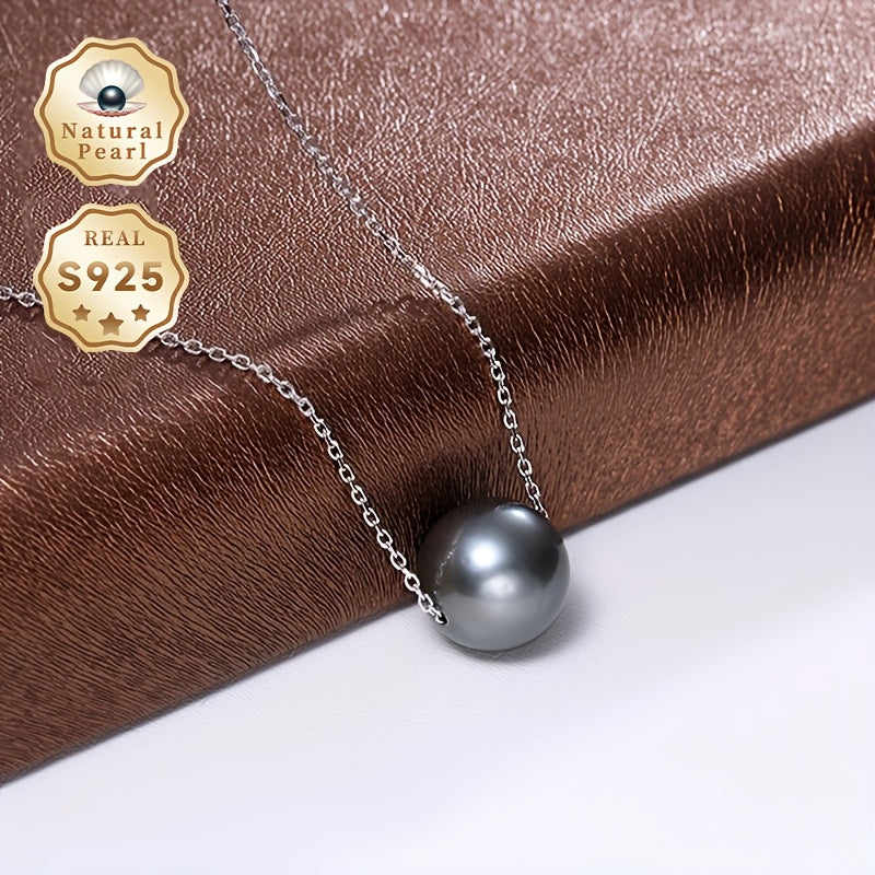 This necklace features a stunning large grain round Tahitian black pearl pendant suspended on a S925 silver chain. Each pearl is unique, so the color and shape may vary. This simple yet elegant piece is perfect for any woman's fashion collection and