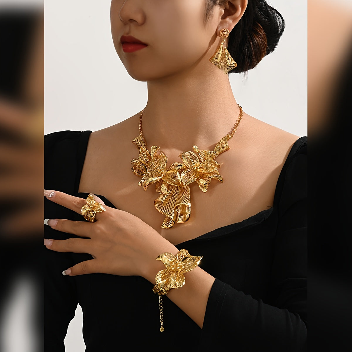 A luxurious jewelry set plated with 18K gold, showcasing a stunning floral necklace, a versatile adjustable ring, and charming pendant earrings - ideal for both everyday wear and special occasions.