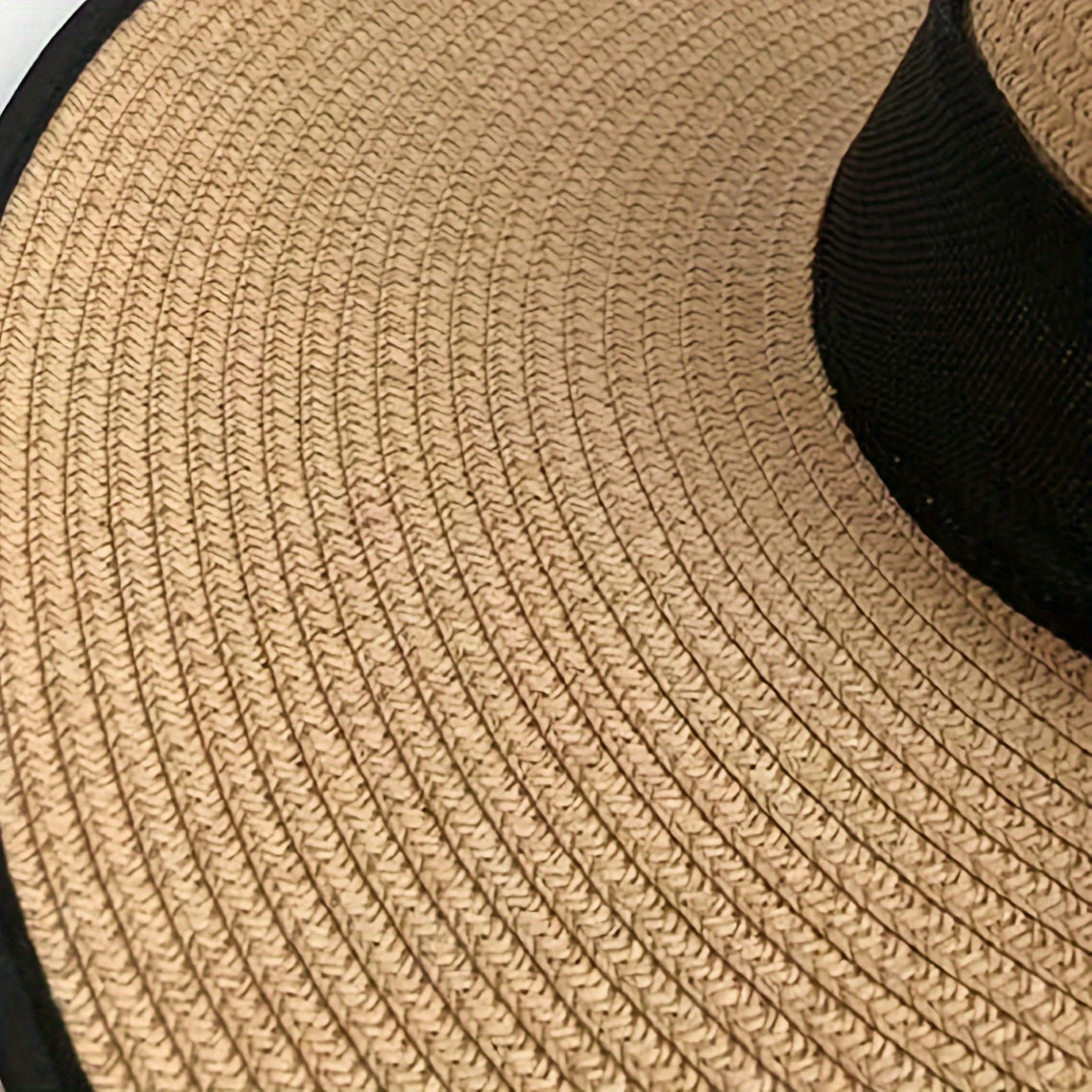 Casual wide brim sun hat with bow, ideal for stylish sun protection at the beach.