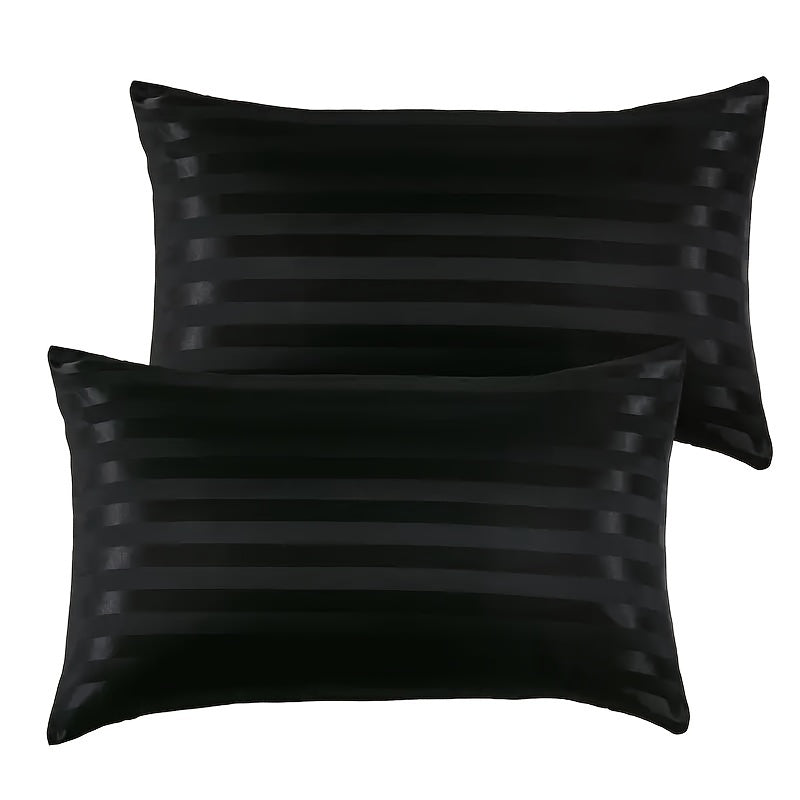 Black pillow cover for bed made of hypoallergenic polyester with a satin stripe design. Machine washable and wrinkle resistant.