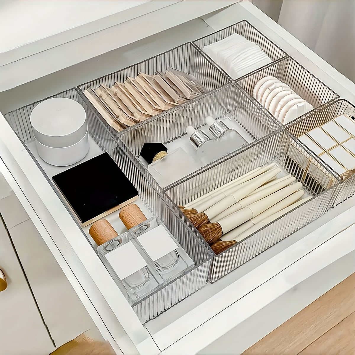 Clear plastic organizer set with customizable drawers for cosmetics and various storage needs, suitable for multiple spaces.