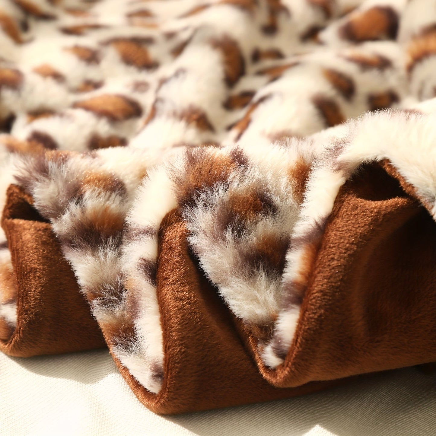 A versatile rabbit plush family blanket with a stylish leopard print design, perfect for all seasons and doubling as a cozy sofa blanket.