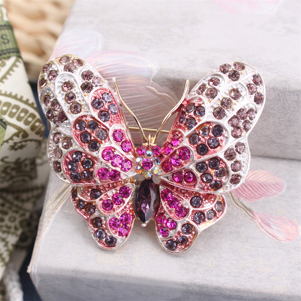 Stylish Rhinestone Butterfly Brooch Pin designed for Women, featuring a Luxurious and Unique Irregular Shape. This Fashion Accessory is perfect for adding a touch of elegance to any outfit. Ideal for Parties or as a special Gift for Couples, this inlaid