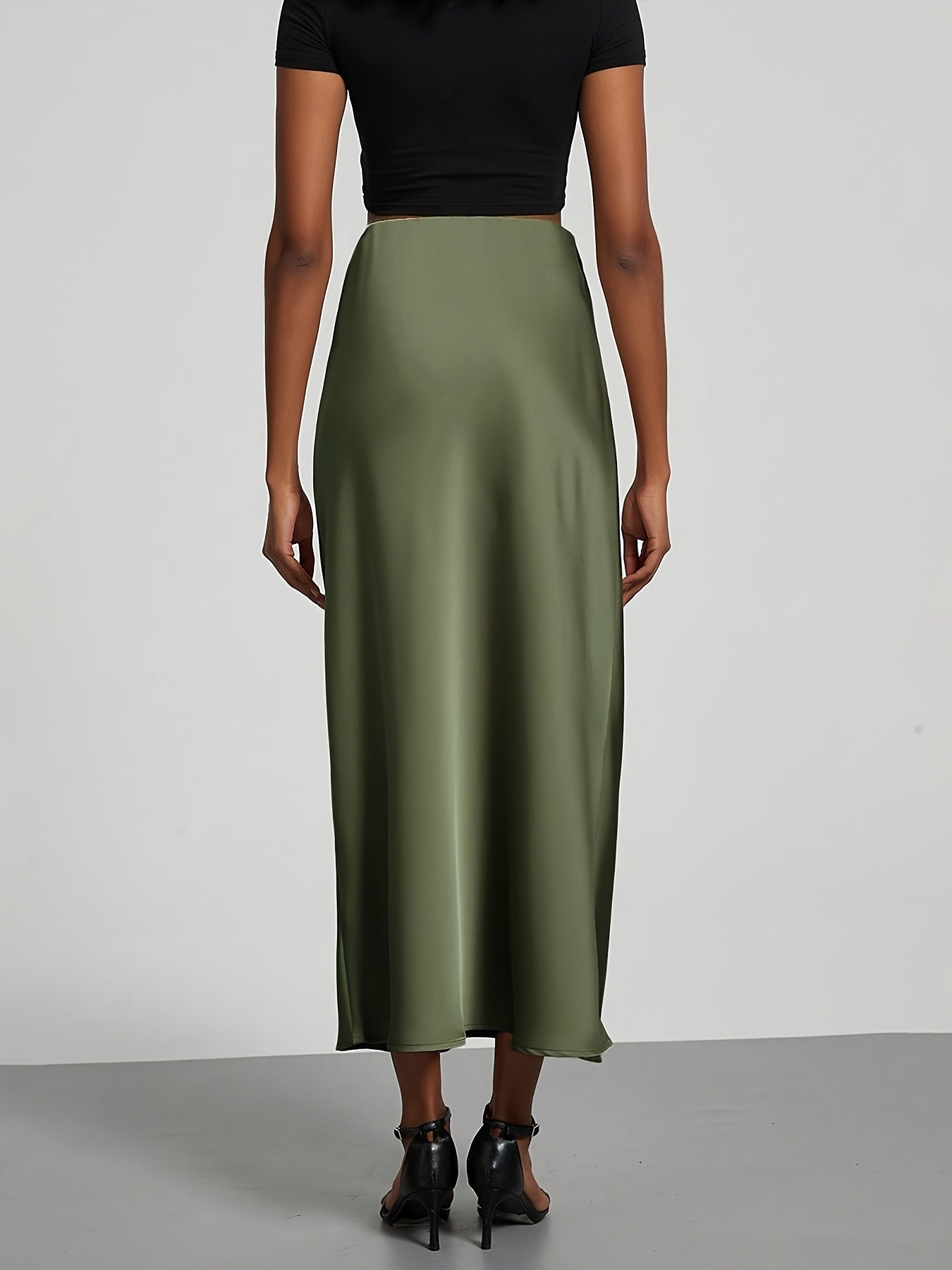 Elegant black high-waisted maxi skirt with A-line cut and smooth satin fabric, perfect for any occasion. Casual chic at its best.