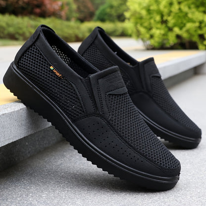 Men's slip-on sneakers with breathable mesh upper, non-slip TPU sole, comfortable fabric insole, solid black design with hook & loop fastener for all-day comfort.