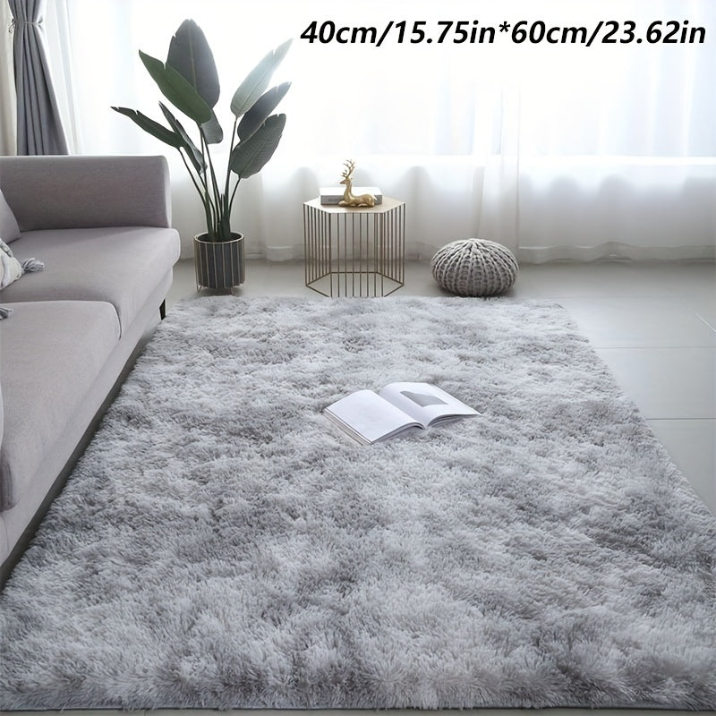 A stylish light grey tie-dye gradient plush carpet perfect for your living room, coffee table, or bedside. This long-haired washable mat is ideal for adding a touch of Nordic style to your bedroom.