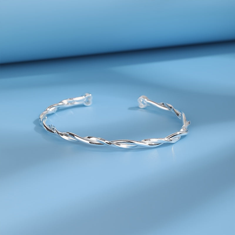 Elegant and simple twisted Möbius band bracelet for women, made of 925 sterling silver with white golden plating. This adjustable open cuff features synthetic zirconia and is hypoallergenic, weighing 9g. Perfect for daily wear or gifting.