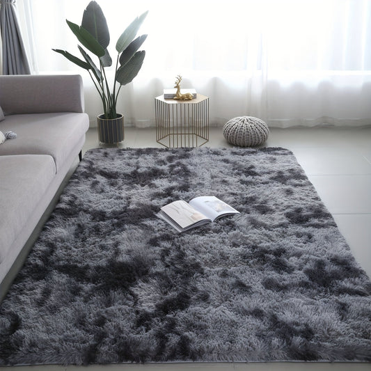 Long fleece carpet in a dark grey tie dye gradient, perfect for the living room coffee table or bedroom decor. This washable mat is fully padded and makes a great Halloween or Christmas gift.