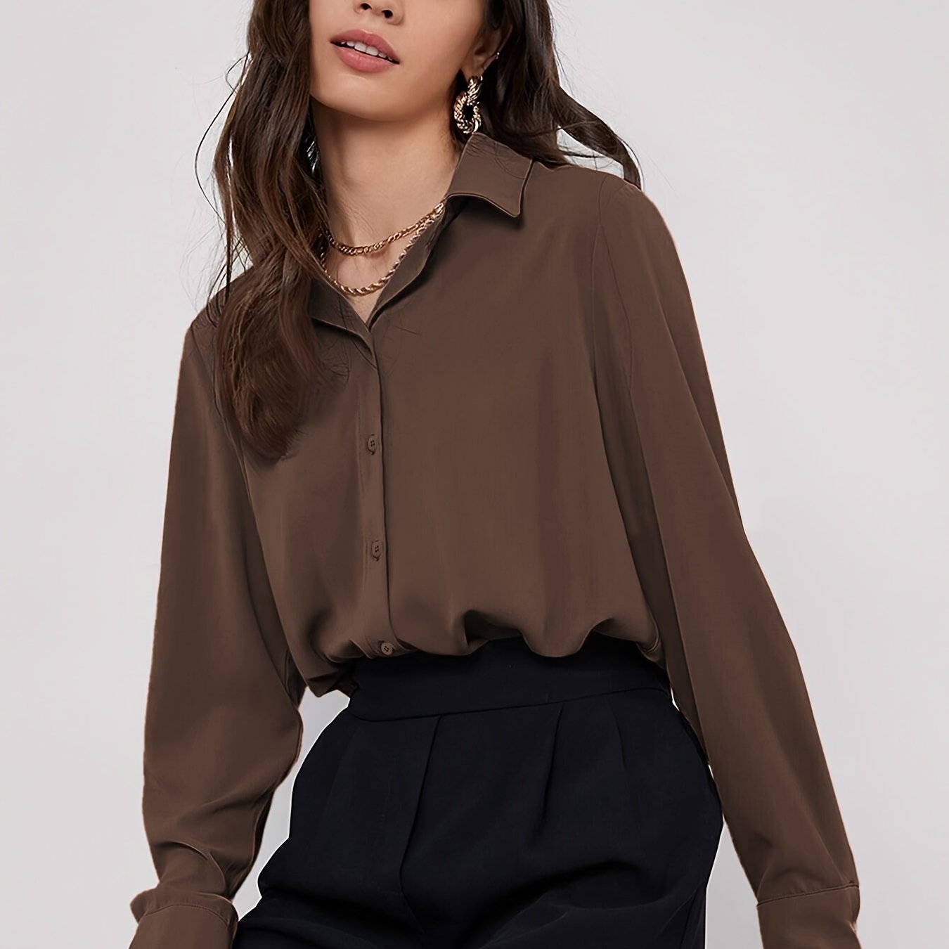 Stylish maroon button-up blouse for women, with long sleeves, curved hem, and made of machine-washable polyester blend. Perfect for work or casual wear.