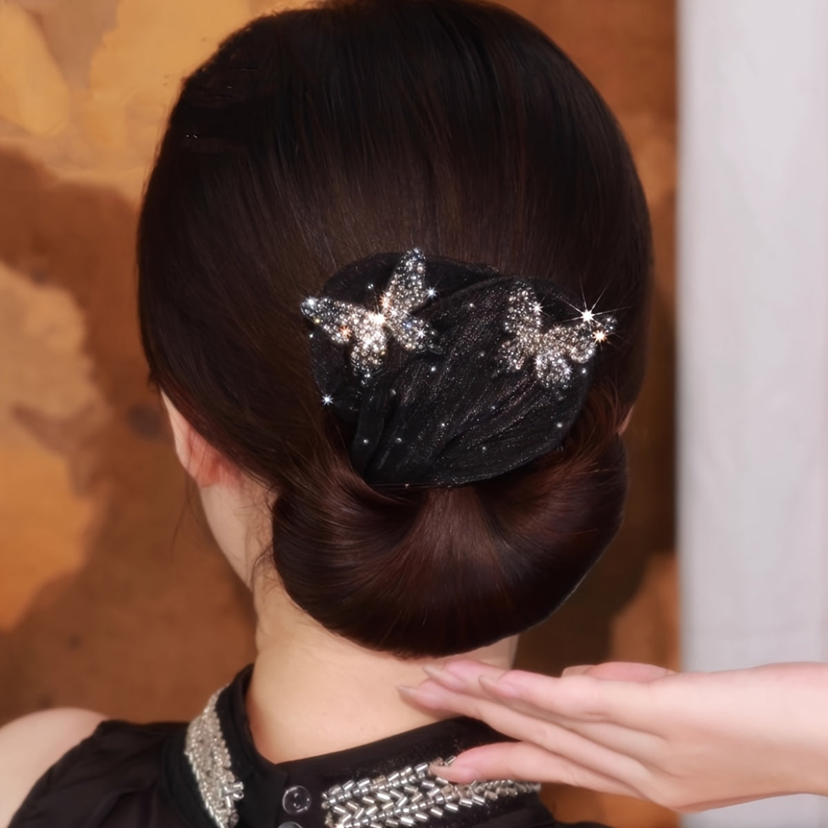 Vintage-inspired hair bun maker with elegant black bowknot design embellished with rhinestones and sequins, suitable for women and girls.