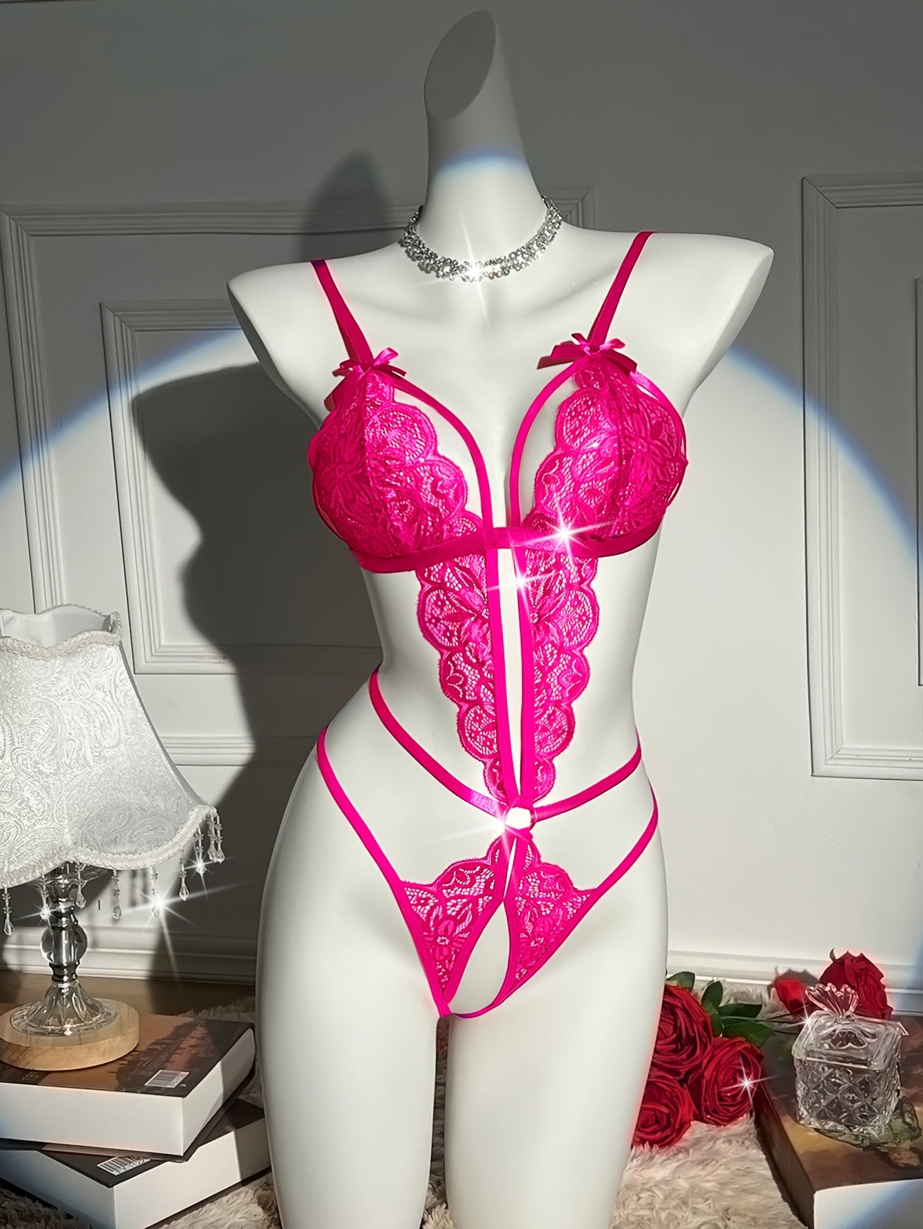 Sexy floral lace teddy bodysuit with open crotch design, bow detail, and medium support - 90% polyamide 10% elastane.