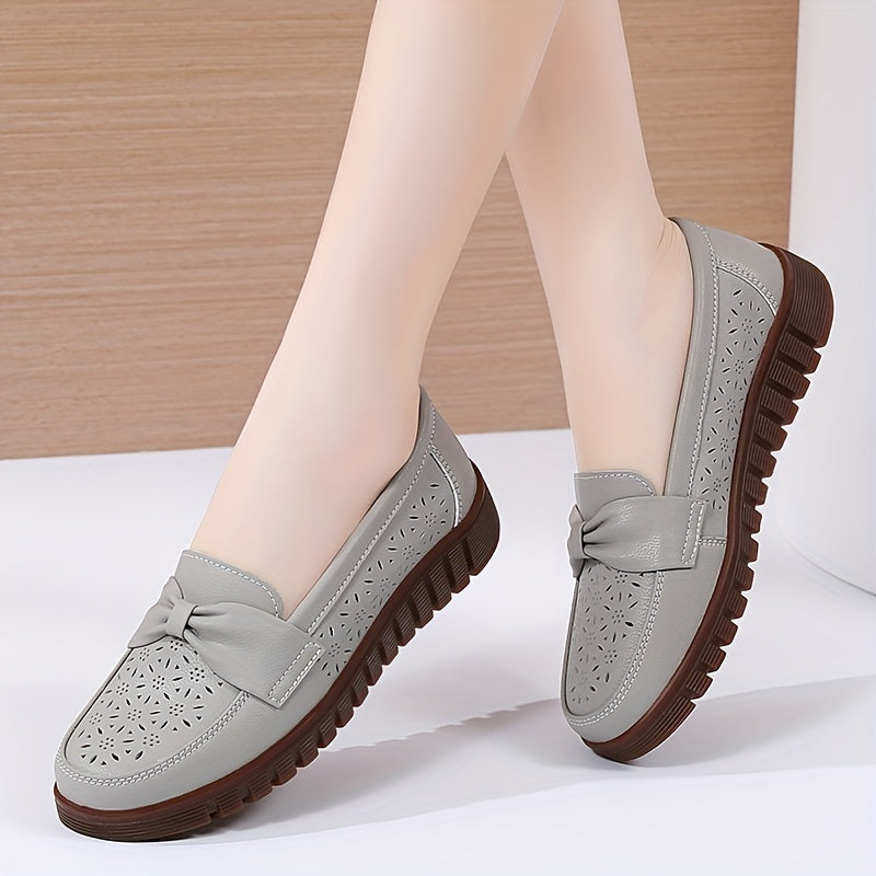 Flat loafers for women with hollow out design, bow detail, soft sole, suitable for casual walking.