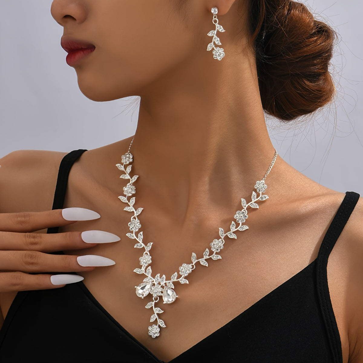 Elegant jewelry set featuring 3 pieces of earrings and a necklace. Adorned with shimmering cubic zirconia, the dainty flower design comes in a choice of silvery or golden tones. Perfect for adding a touch of glamour to your evening party ensemble.