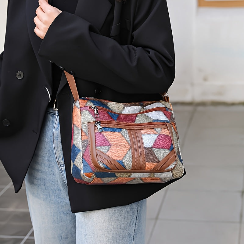 Women's red crossbody purse with adjustable strap, multiple zippered compartments, and geometric stitching design.