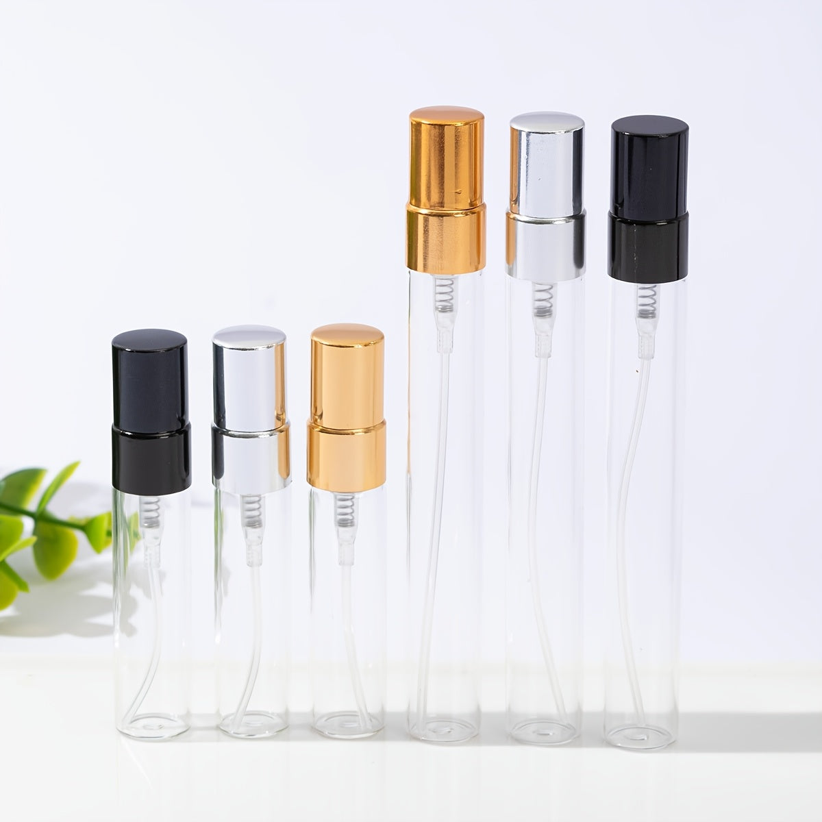 50 transparent glass bottles for decanting 5ml and 10ml perfumes, with spray tops.