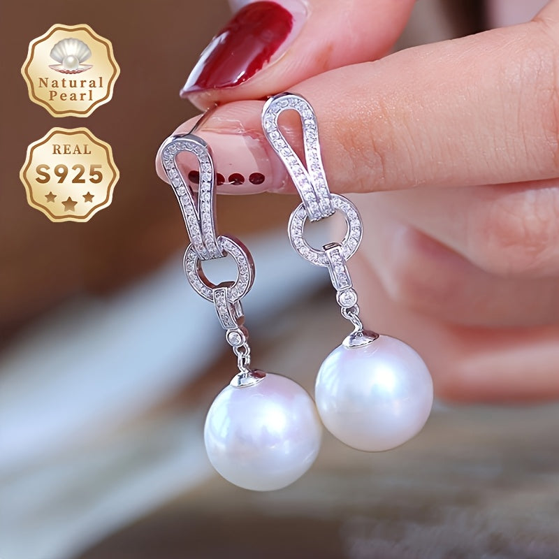 Add a touch of elegance to your collection with these must-have Pearl Dangling Earrings. Crafted with 13-14mm round natural freshwater pearls, these fashionable long earrings are made of S925 silver. Each pair is unique and features varying shapes and