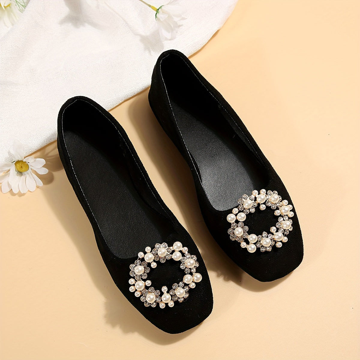 Women's black flat shoes with embellishments and comfortable fabric upper. Suitable for casual or formal occasions. Versatile and durable rubber sole.