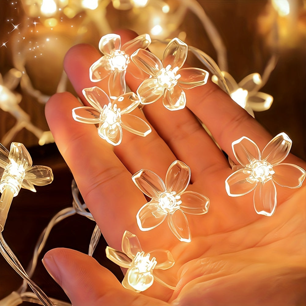 Battery-operated LED cherry blossom string lights, warm yellow, for home decor, weddings, Christmas, and parties. Made of plastic with a transparent wire, available in multiple lengths (batteries not included).