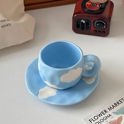 Handcrafted ceramic coffee mug and saucer set with whimsical patterns. Reusable and recyclable, perfect for tea or latte. Hand wash only.