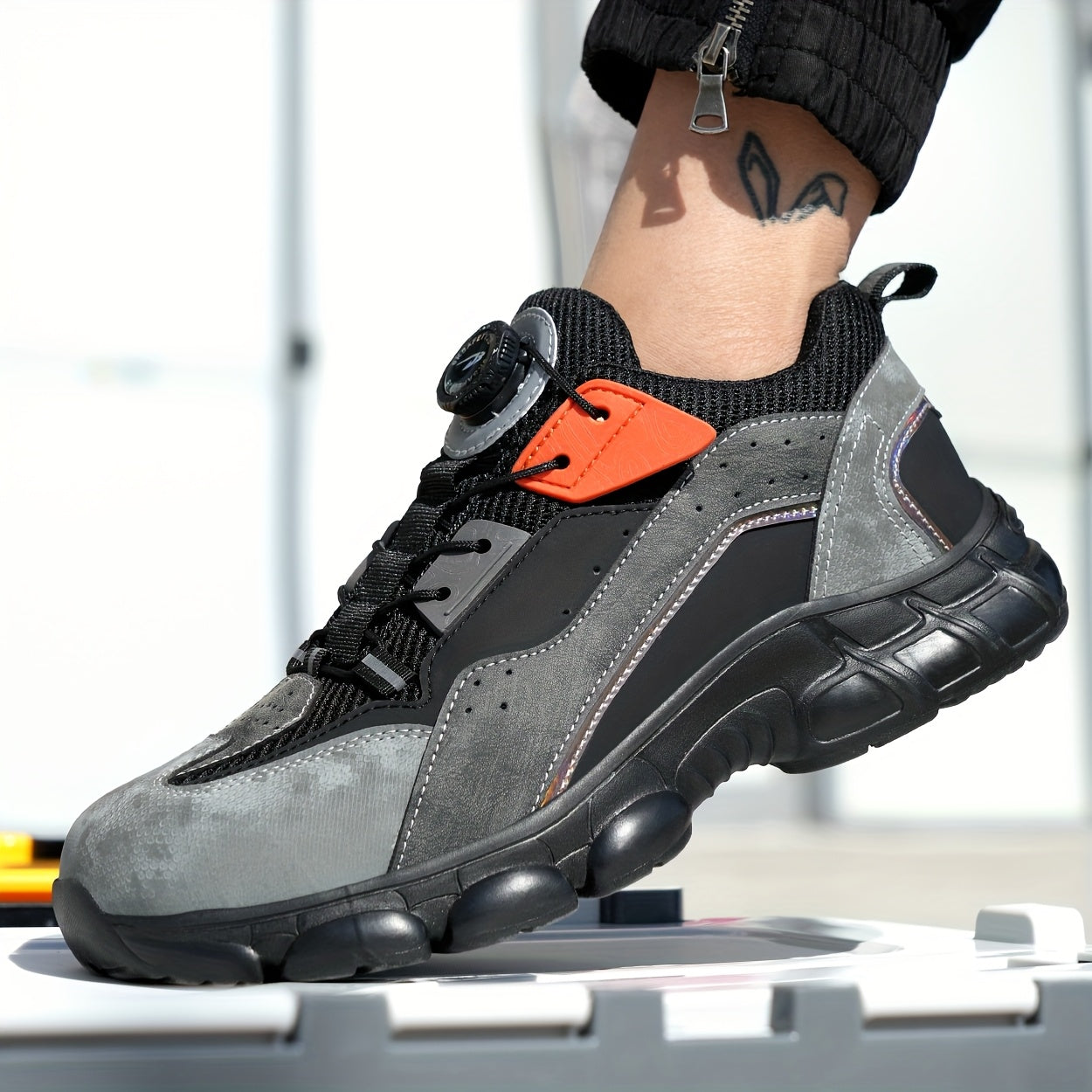 Steel toe work shoes with breathable design, puncture-resistant sole, and durable fabric upper in gray/black/orange. Perfect for construction and industrial tasks.