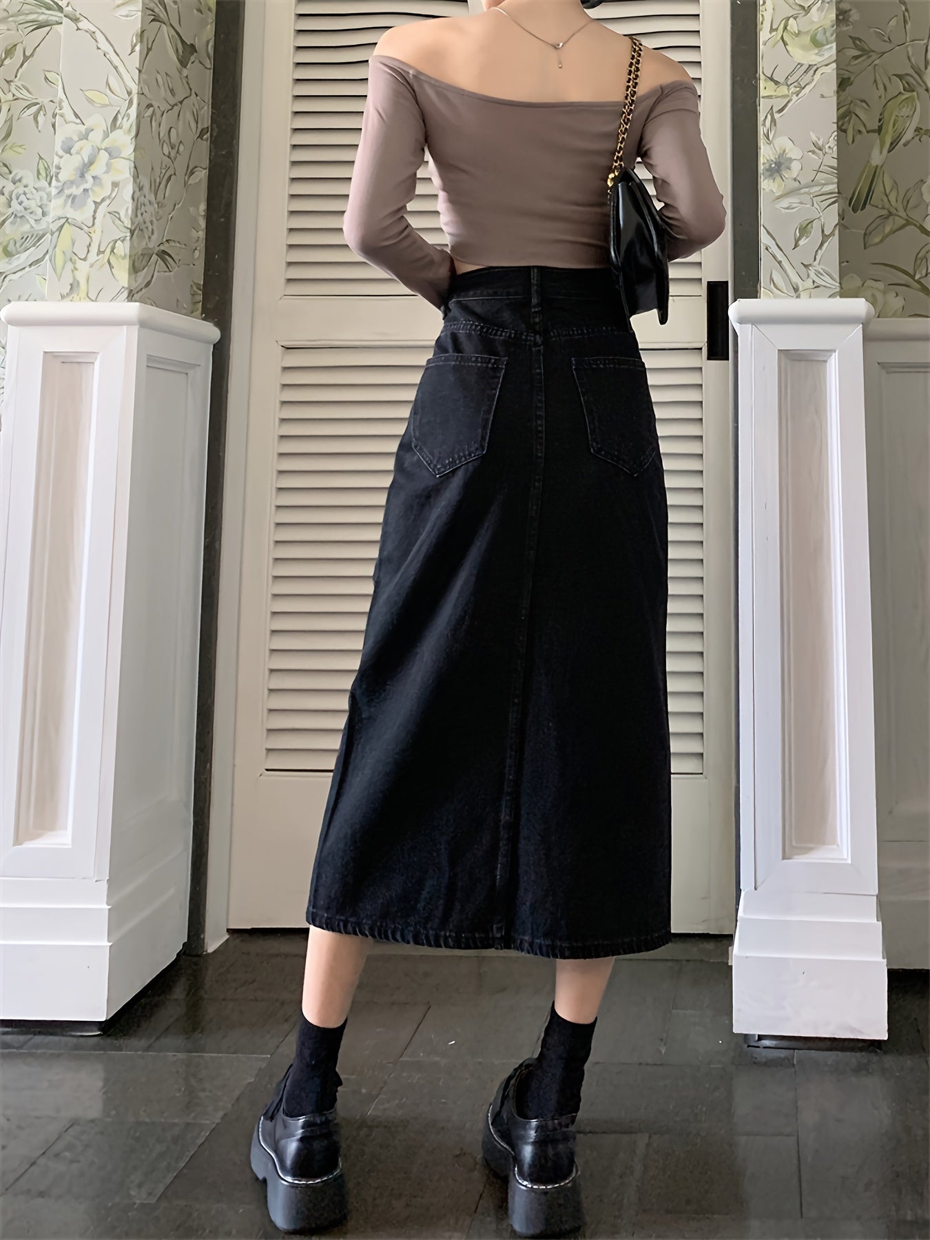 Stylish black denim midi skirt with front slit - machine washable, great for summer.