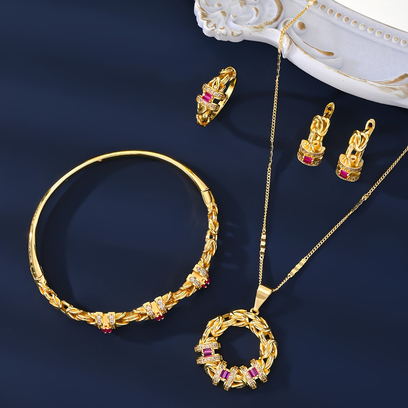 Luxurious Dubai-inspired jewelry set crafted with simple brass material and 18k Gold Plating, adorned with Zirconia stones. This elegant 5-piece set includes a necklace, earrings, bracelet, and ring, perfect for daily wear or as a special gift. The Retro