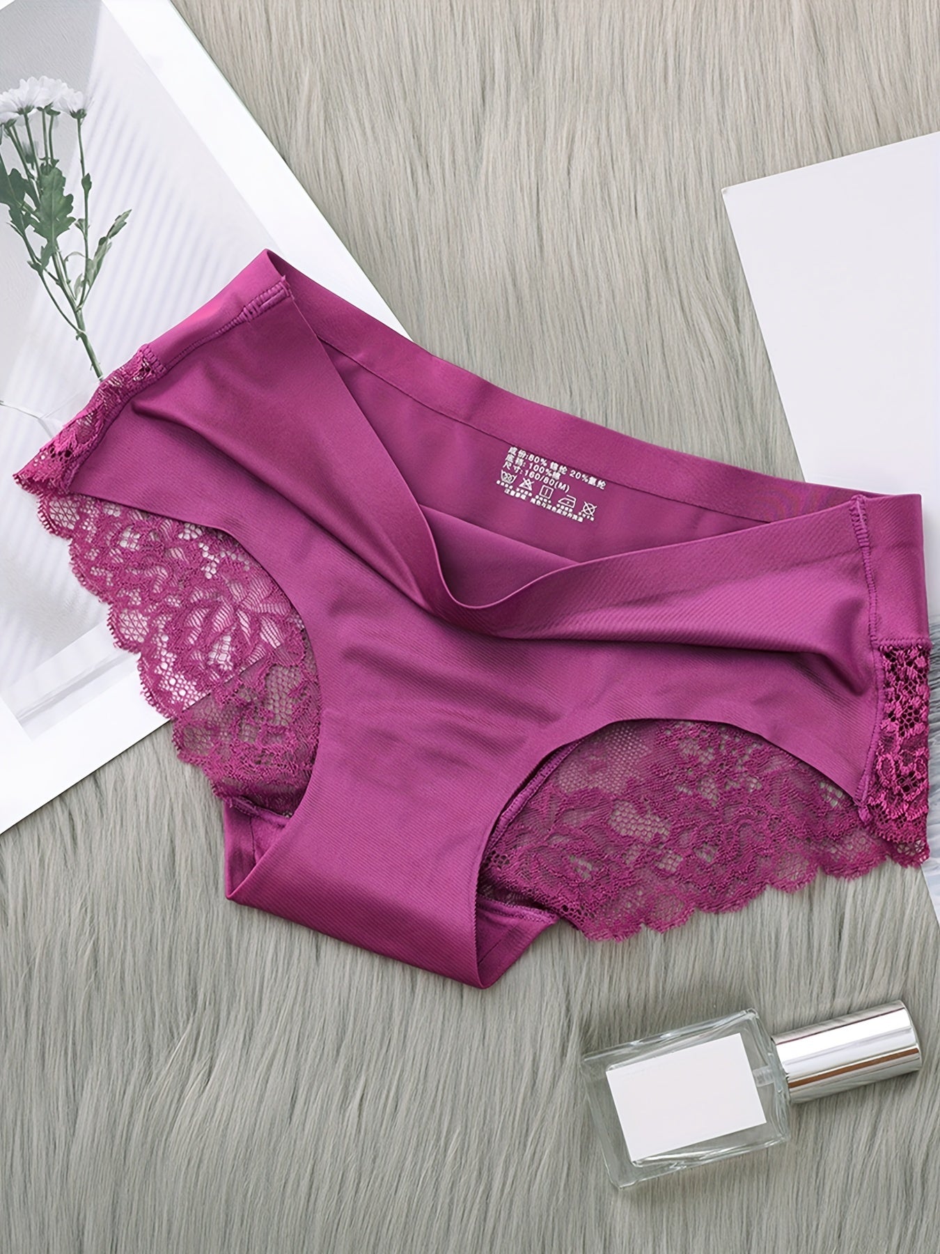 Set of 4 nylon knit fabric mid rise panties for women with solid color and lace details.