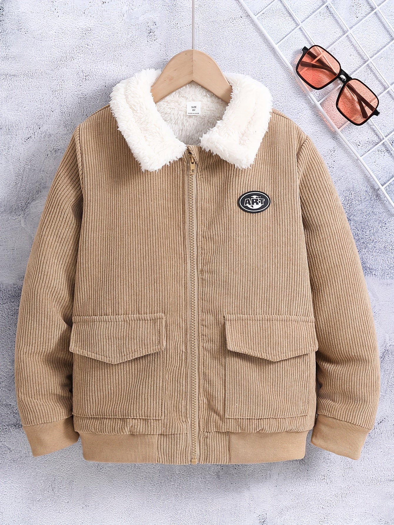 Boy's warm jacket with thick fleece lining, ideal for fall and winter outdoor wear.