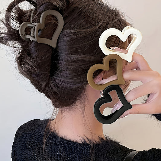 4 heart-shaped plastic hair clips for women, medium-sized with strong grip and durability, perfect for hairstyle coordination.