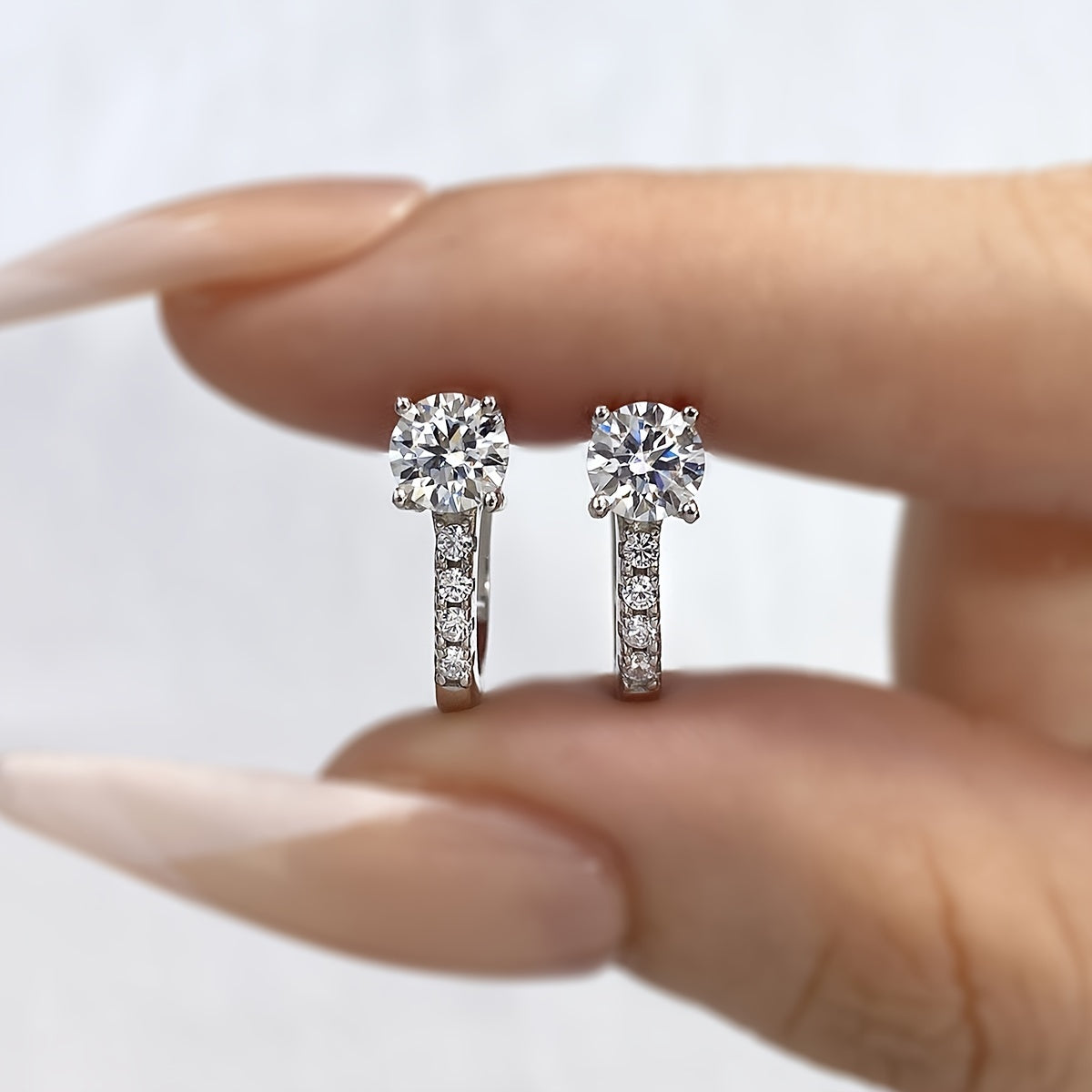 These elegant U-shaped earrings feature 1CT shiny moissanite stones set in 925 sterling silver. They make a perfect Valentine's Day gift and are ideal for weddings. With a luxurious and noble design, these earrings weigh approximately 2.4 grams and each