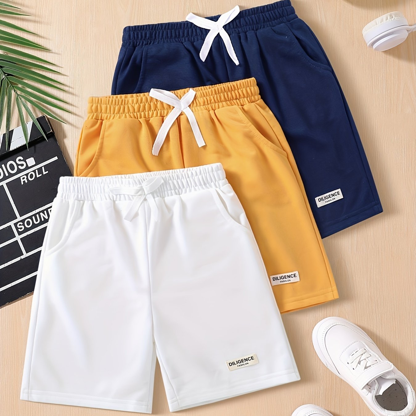 Three-pack of boys' summer shorts in solid colors, made from polyester knit with slight stretch, featuring elastic drawstring waist and regular fit. Ideal for sports and leisure activities