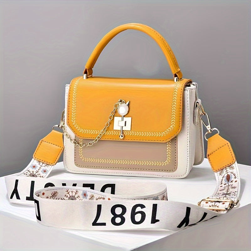 Stylish two-tone women's handbag with adjustable printed strap, made of PU material.