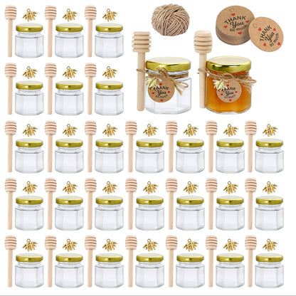 Small hexagonal glass honey jars come in 1.5 oz sizes in sets of 20, 30, 50, or 60. Each jar includes a spoon, bee symbol, and thank you card. They have golden lids and are ideal for baby gifts, weddings, and parties.