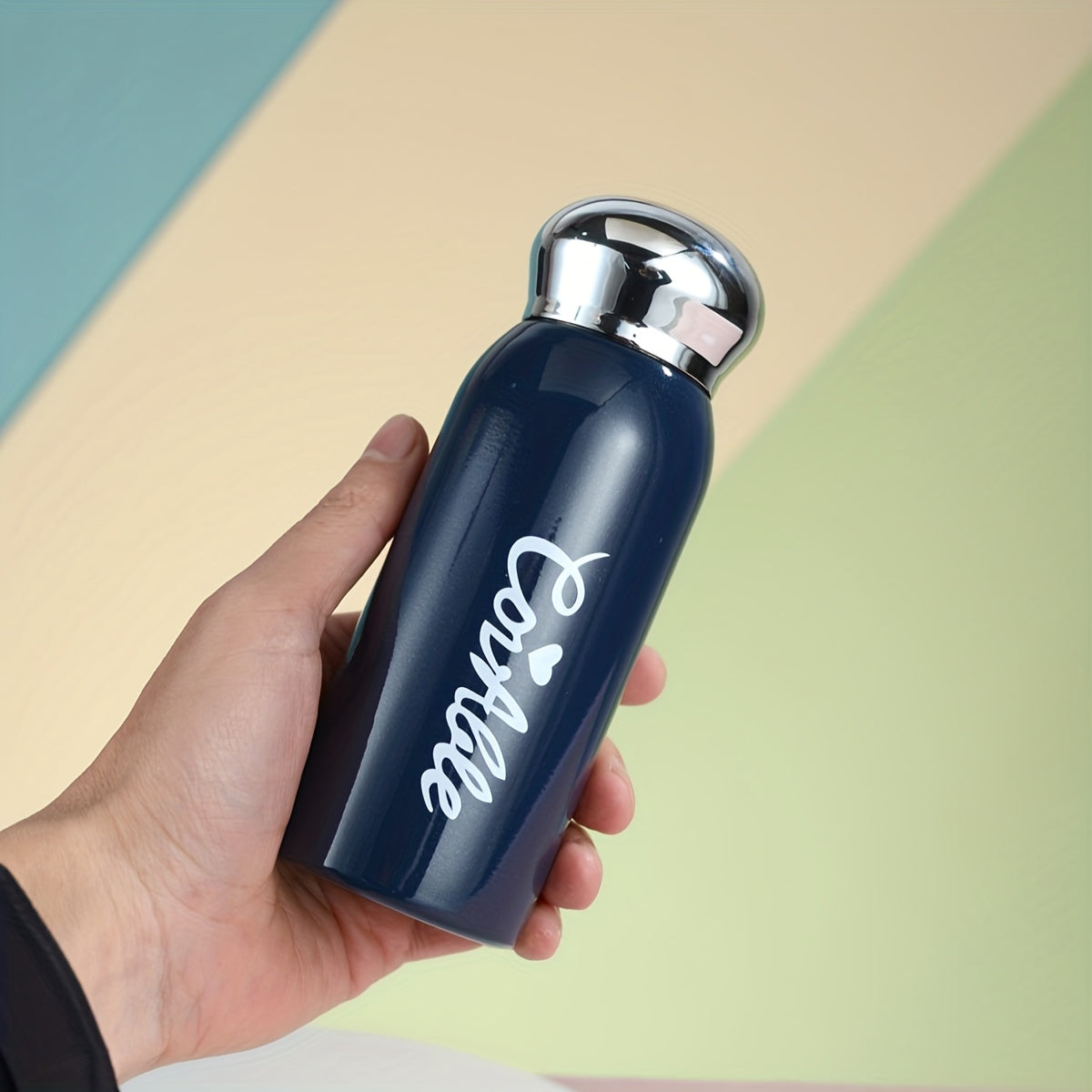 Small stainless steel vacuum flask with electroplated lid for on-the-go hydration. Ideal for students.