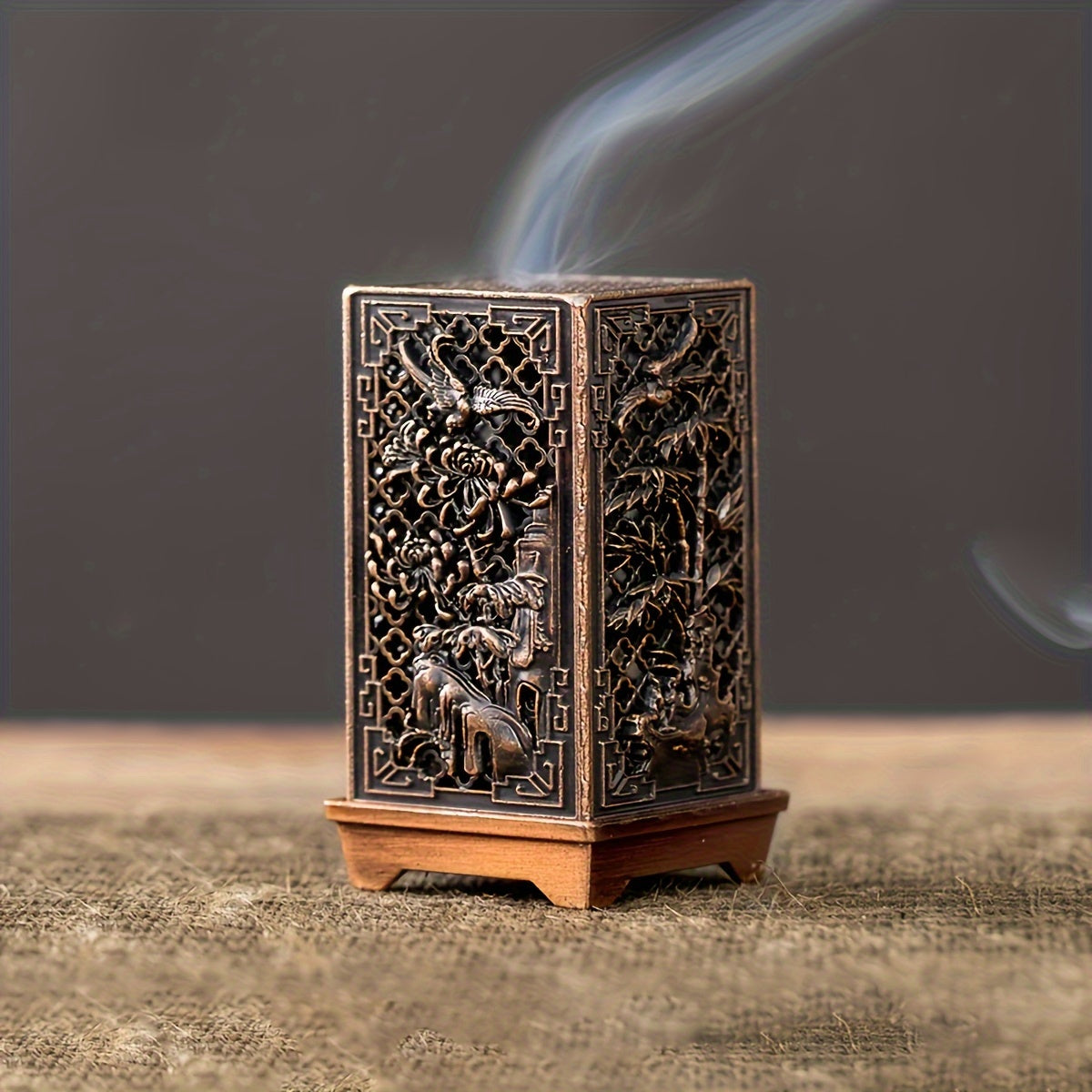 Stylish incense burner with bamboo and plum blossom design in copper/gold finish for home or office décor.