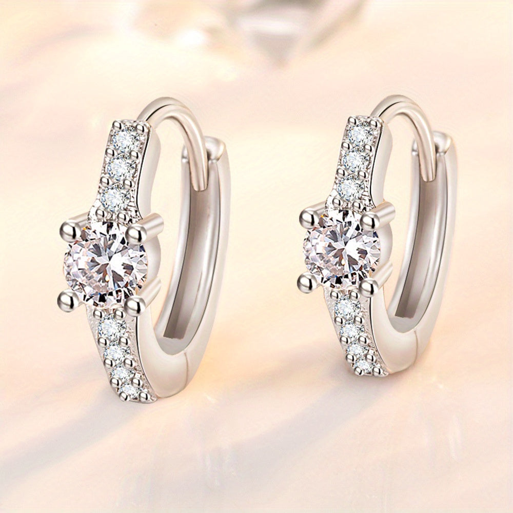 A chic and stylish pair of S925 Silvery earrings, featuring a retro, exquisite design with trendy and luxurious appeal. These earrings exude elegance and sweetness, adorned with shiny rhinestones in a round hollow shape. The high-end design showcases a