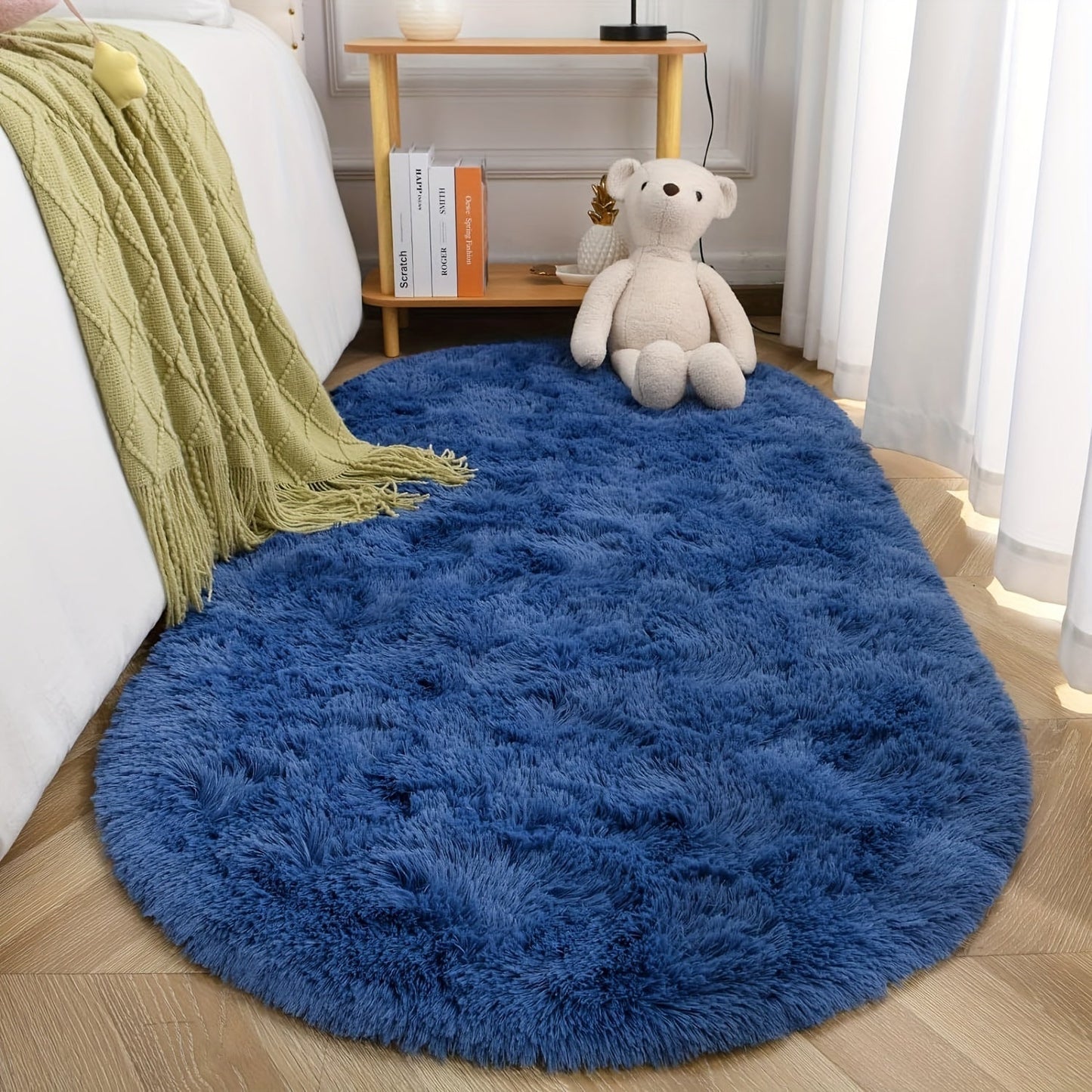 Soft and fluffy oval shaggy area rug, perfect for bedroom or living room. Made with skin-friendly thickened sponge and tufted polyester material. Durable and easy to maintain. Adds decorative touch to indoor spaces such as sofa, bedside, playroom, or