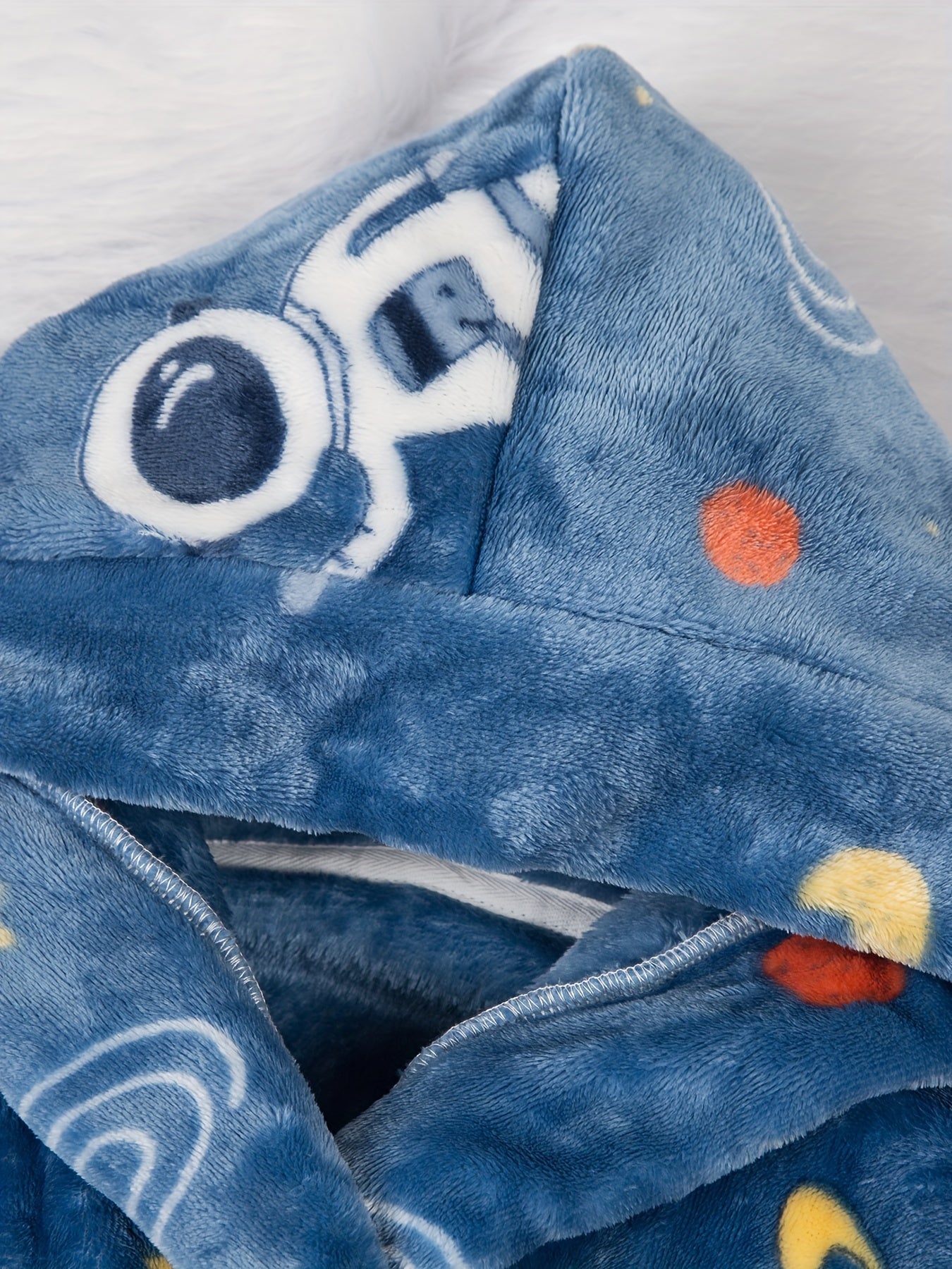 Soft and cozy space-themed boys' fleece robe with flame retardant technology. Features long sleeves, hood, pockets, and is machine washable. Ideal for home and party wear, perfect gift for