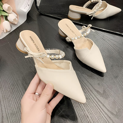 Stylish French-inspired mules for women, featuring a faux pearl ankle strap and chunky heel, perfect for outdoor wear in Summer 2024.