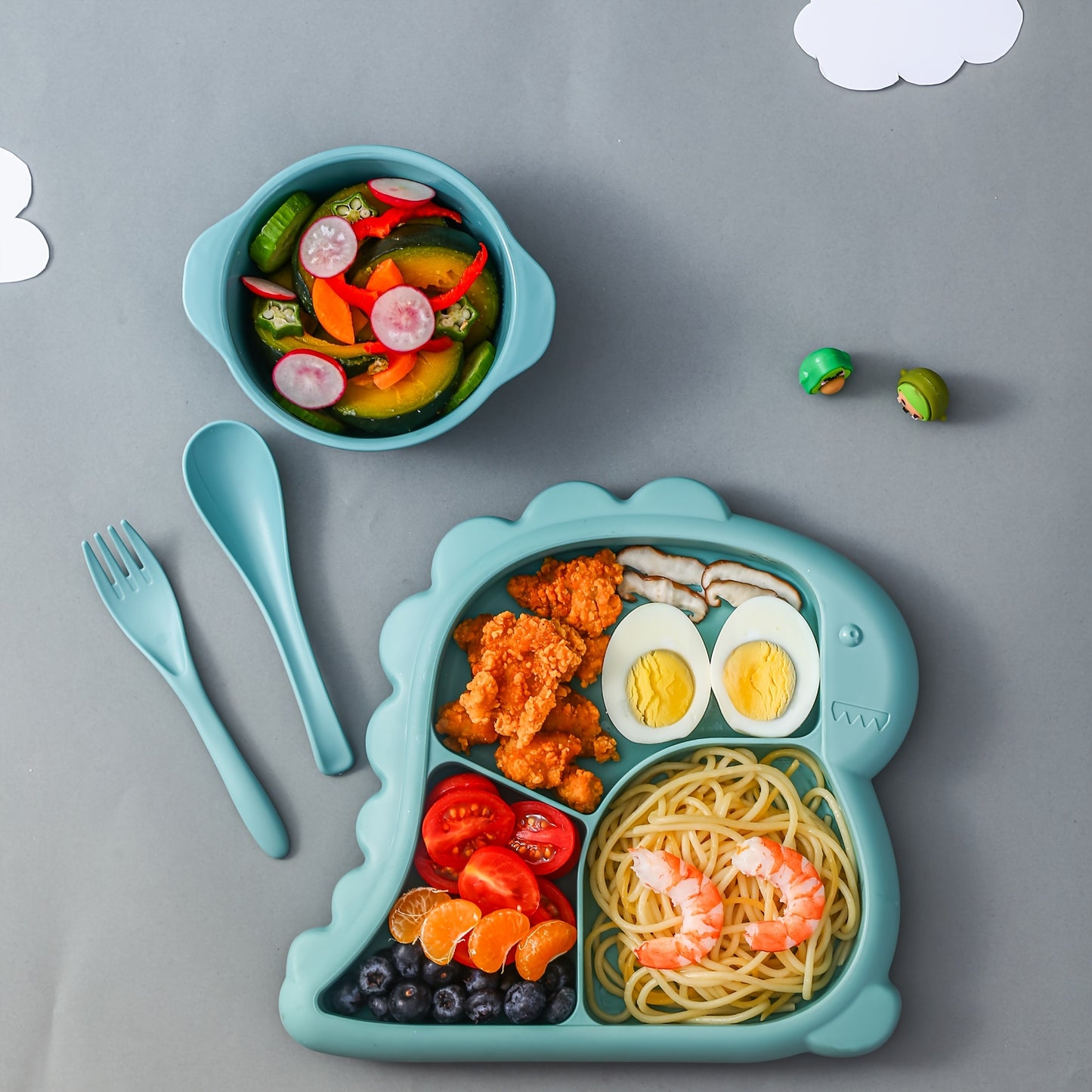 Children's dinnerware set shaped like dinosaurs - made of BPA-free plastic includes plate, bowl, fork, and spoon.