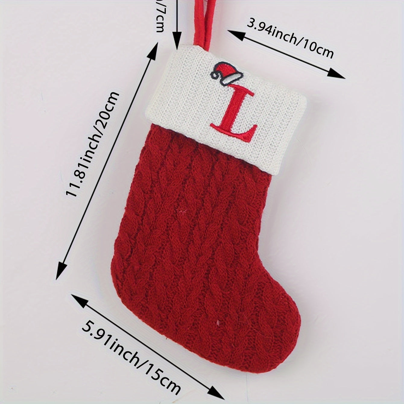 Knitted letter Christmas socks for home tree ornaments; red socks in gift bag for festive attire.