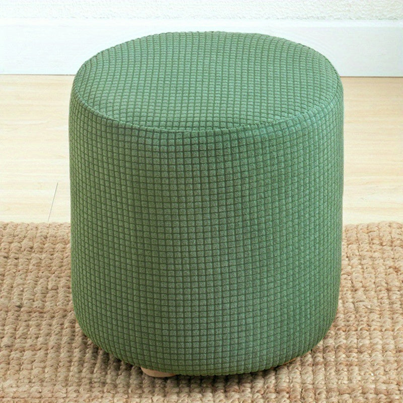 Stretchable round footstool cover made from soft polyester blend with elastic fit. Available in multiple colors, machine washable, modern design for living room ottomans.