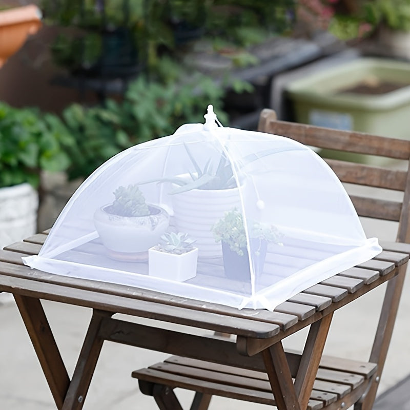 White portable mesh food cover for picnics and travel, protecting food from insects and dust.