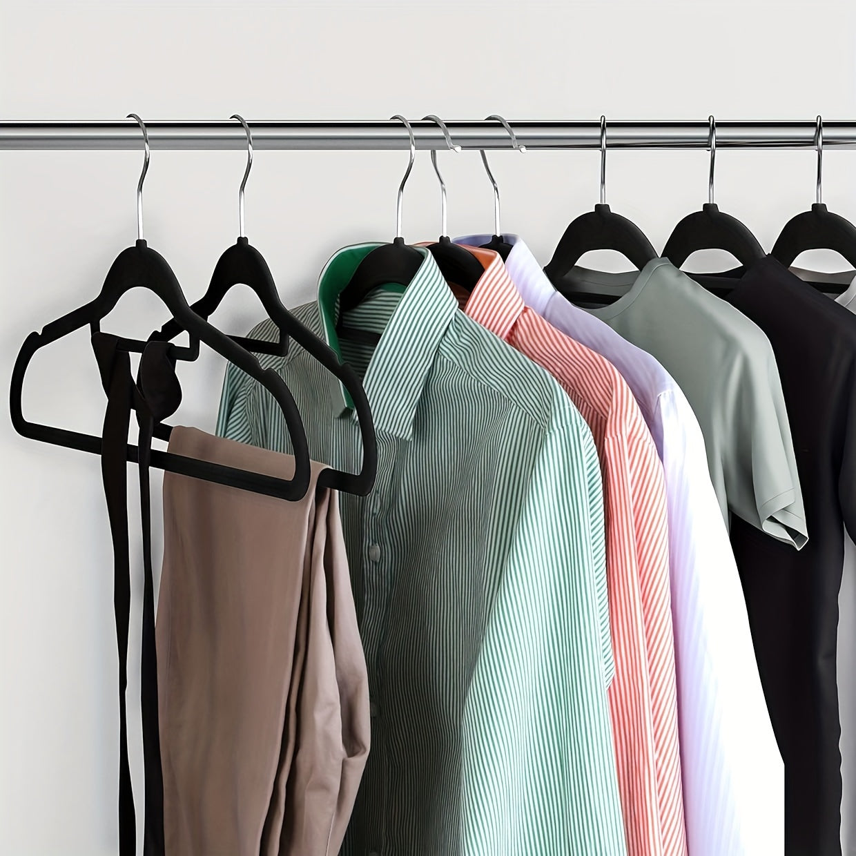 Upgrade your wardrobe organization with this set of 50 sleek black velvet hangers. These non-slip hangers feature 360° swivel hooks and a slim design, perfect for suits, coats, dresses, and more. Made from durable ABS plastic, these hangers are ideal for