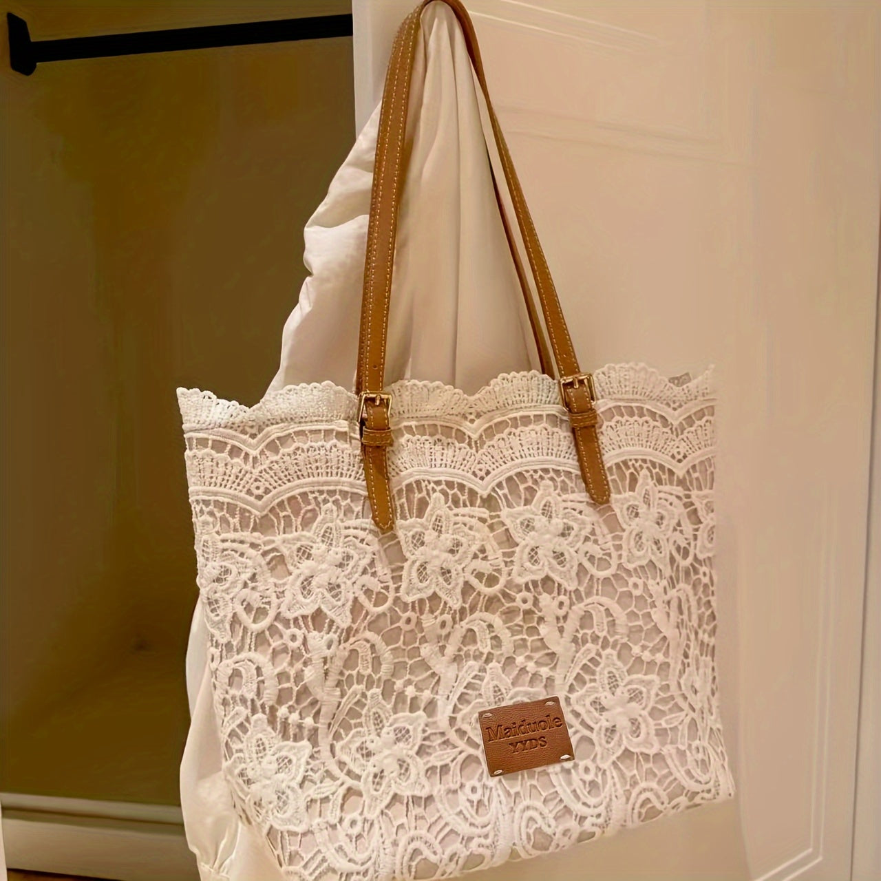 Stylish lace shoulder bag for women, with adjustable strap, foldable design, kiss lock closure, and wristlet accessory - perfect for daily use.