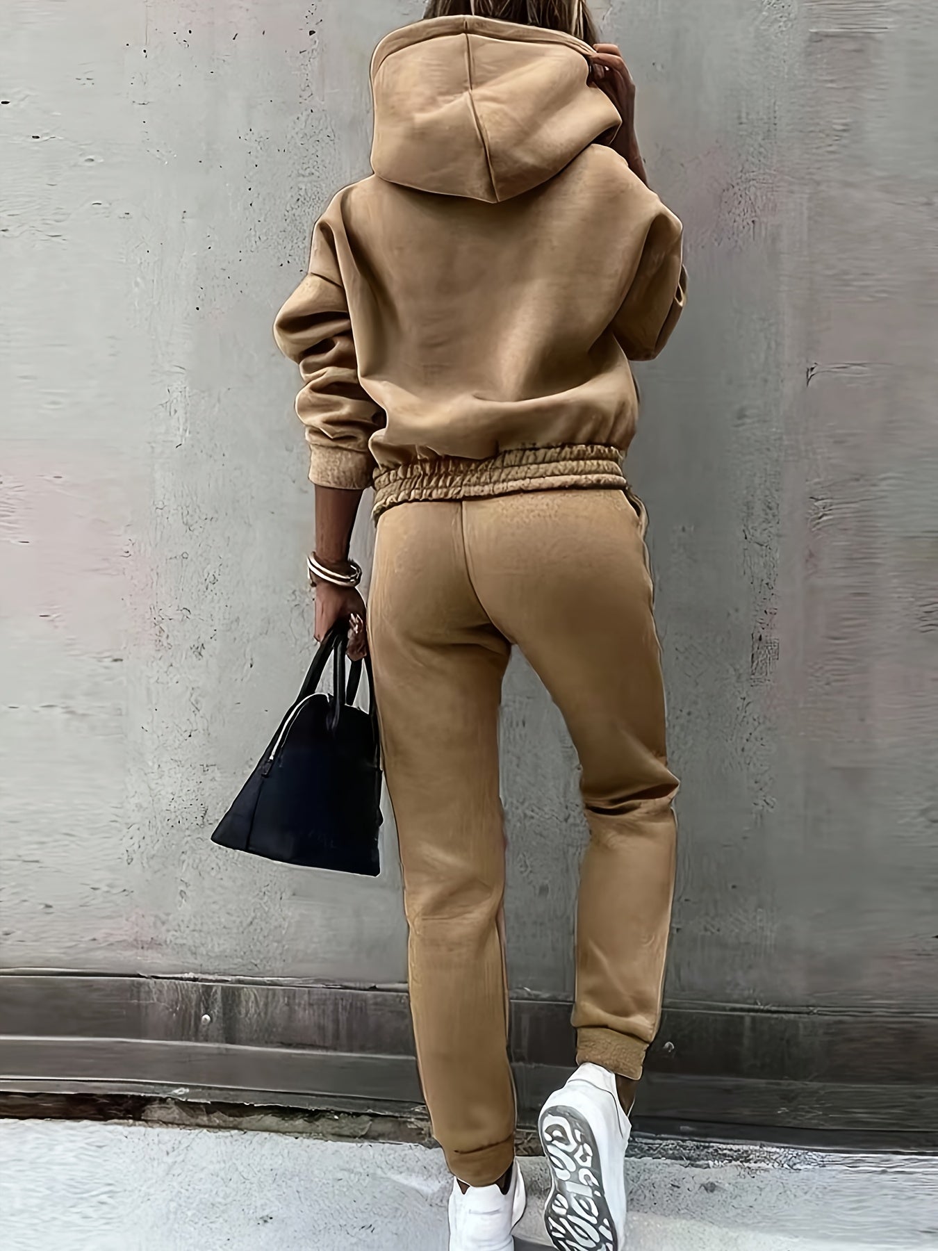 Women's solid color sweatpants set with long sleeve hoodie and drawstring jogger pants.