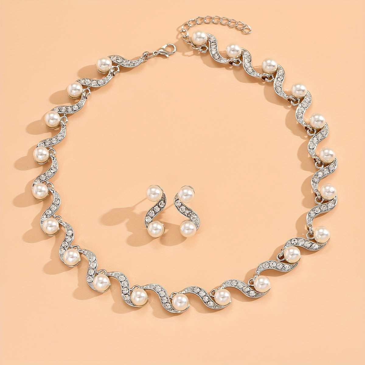 Stunning imitation pearl and diamond jewelry set, ideal for brides to wear on their special day.